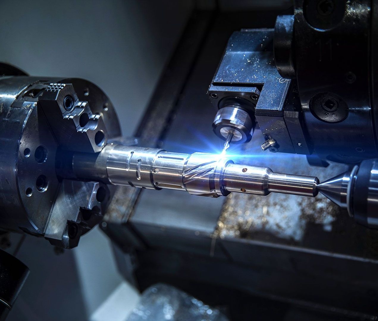 Close-up of CNC milling/drilling machine machining process in metal factory.